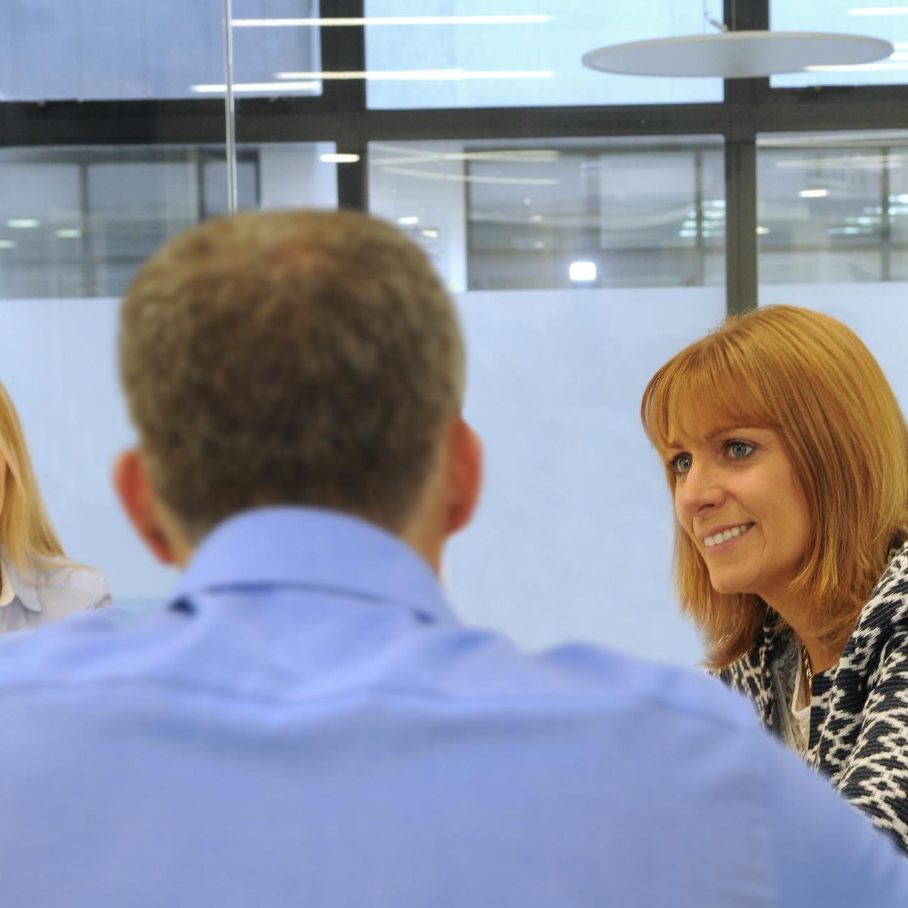 Close up of MB with head of client and other in background Close up of MB with head of client and other in background