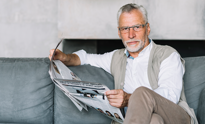 elderly-man-sitting-sofa-reading-newspaper elderly-man-sitting-sofa-reading-newspaper